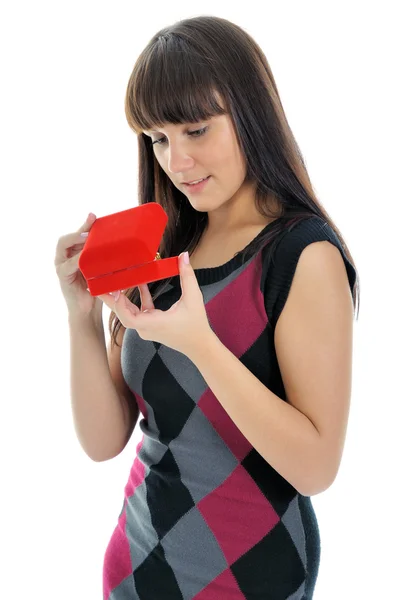 Beautiful brunette opening a red gift box. — Stock Photo, Image