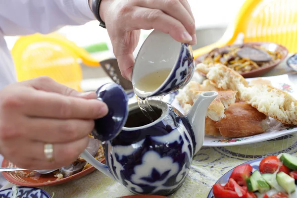 stock image Pouring of tea after lunch