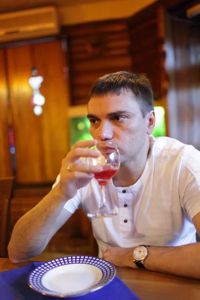 Человек пьет фруктовый напиток — стоковое фото