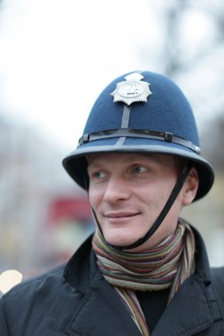 Happy man in british police hat clipart