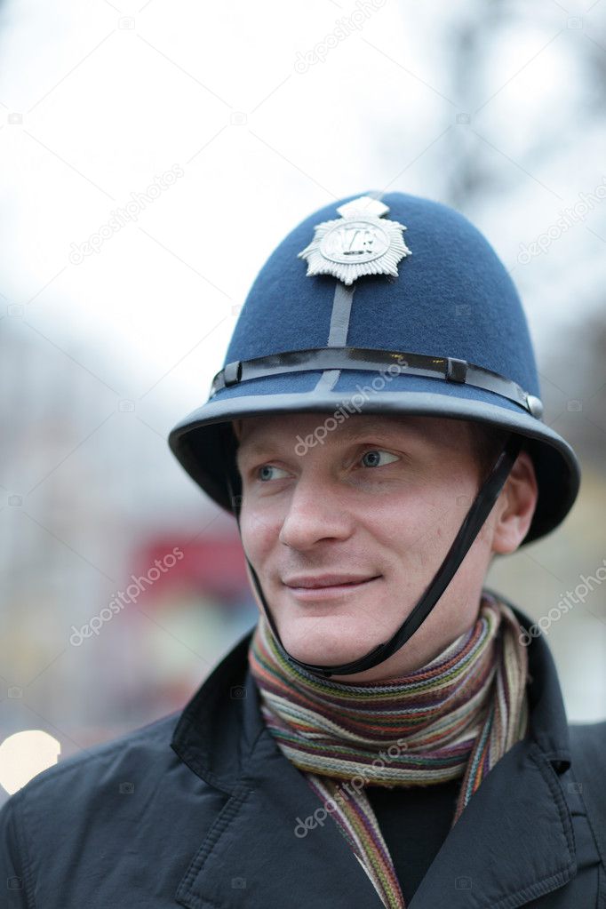 Happy man in british police hat