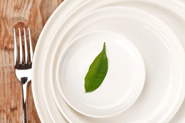Leaf on the white plates — Stock Photo, Image
