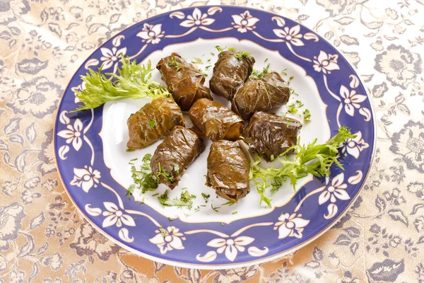 stock image Vine leaves stuffed with rice (dolmades served on a plate)