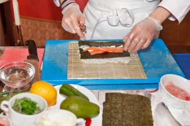 Chef preparing sushi in the kitchen clipart