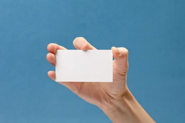 Business 's hand holding blank white paper business card — стоковое фото