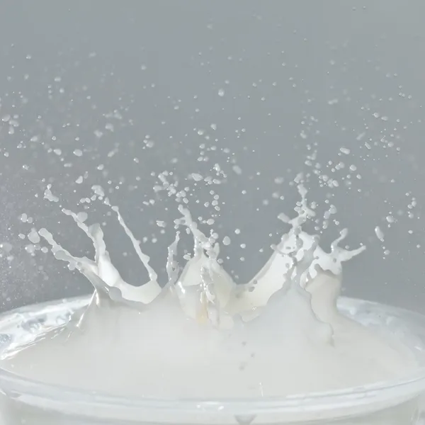 Splash in a milk glass — Stock Photo, Image