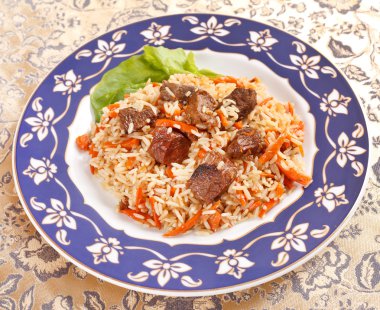 Uzbek national dish - plov on the plate clipart