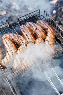 Hot sausages on barbecue clipart