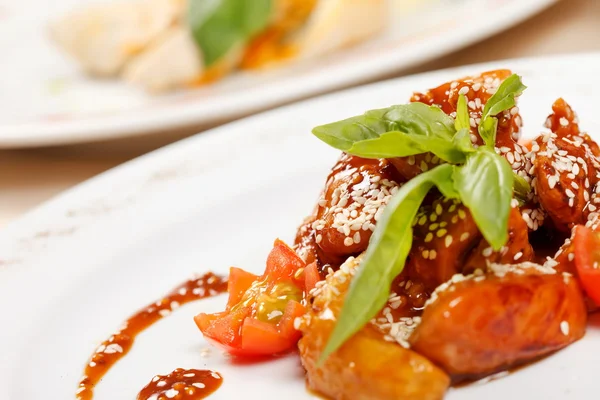 stock image Portion of sesame chicken served on a white plate