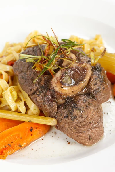 Tasty steak with pasta — Stock Photo, Image