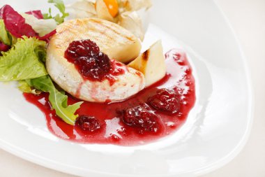 Camembert with cherry sauce clipart