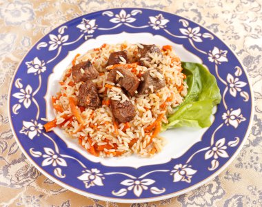 Uzbek national dish - plov on the plate clipart