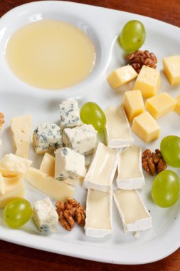 Cheese plate with grapes and honey clipart