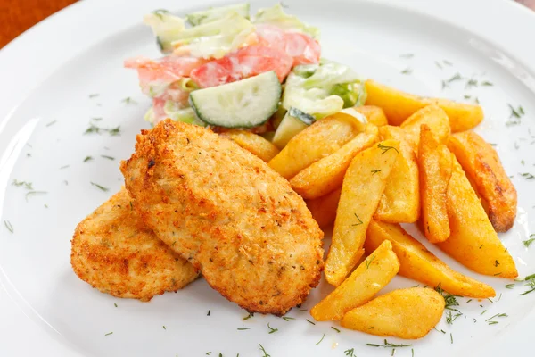 Chicken cutlet with fried potatoes — Stock Photo, Image