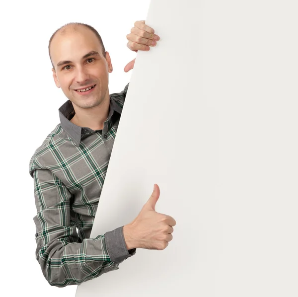 Smiling young handsome man with blank banner — Stock Photo, Image