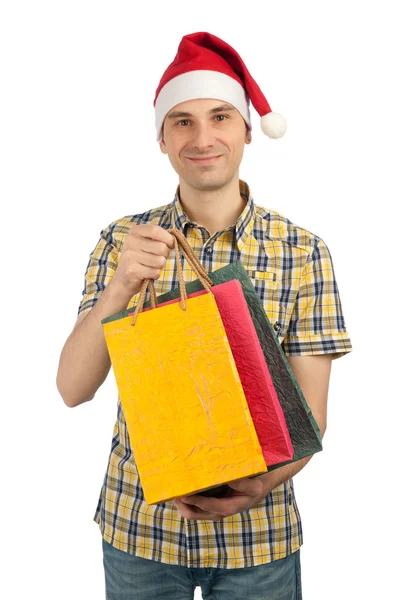 Man in Christmas hat with with gifts — Stock Photo, Image