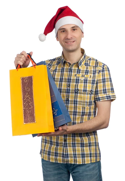 Az ember egy santa kalap a karácsonyi ajándékokkal — Stock Fotó