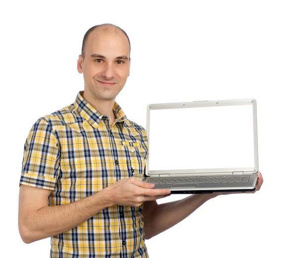 Retrato de um jovem exibindo um computador — Fotografia de Stock