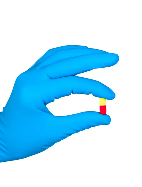 Mão na luva com pílula isolada no fundo branco . — Fotografia de Stock