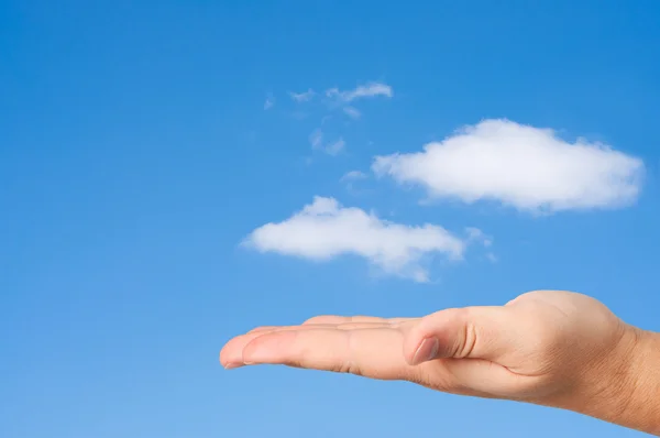 Hand i himlen moln bakgrund. — Stockfoto
