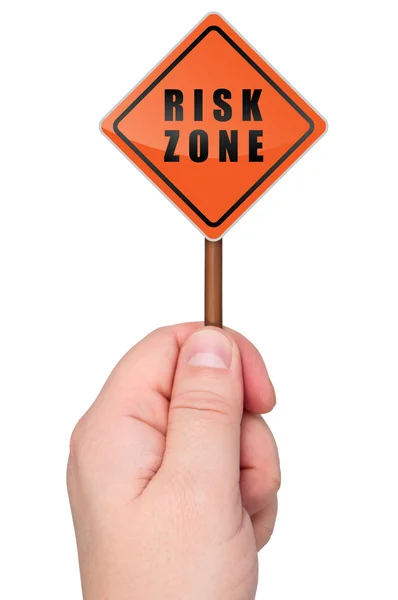 Warning sign risk zone holds in hand. — Stock Photo, Image