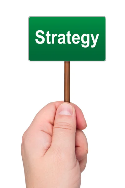 Πινακίδα με την λέξη στρατηγική που κρατά στο χέρι απομονωθεί. — Φωτογραφία Αρχείου