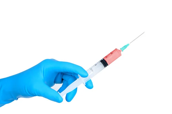 Hand in medical rubber glove holding medical syringe. — Stock Photo, Image