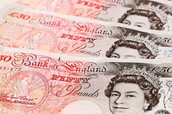 50 pound sterling bank notes closeup view business background