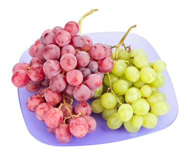 Red and white grapes bunches on blue plate isolated on white clipart