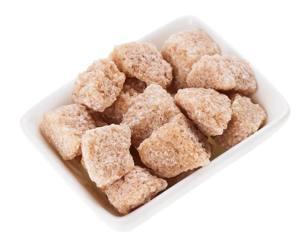 Brown lump cane sugar in a rectangular sugar-basin, isolated on — Stock Photo, Image