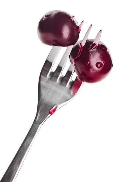 Two bloody cherry fruits pricked on metal fork, isolated on whit — Stock Photo, Image