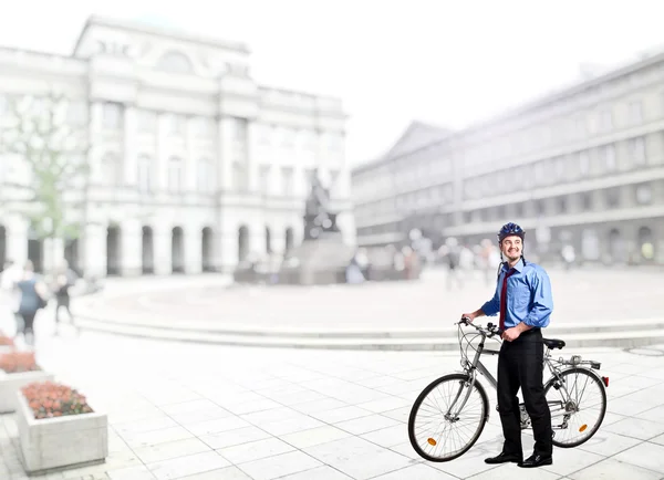 Businessman with bicycle — Stock Photo, Image