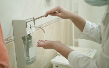 Health occupation worker washing her hands clipart