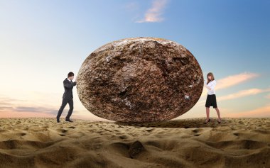 Businessman rolling a giant stone clipart