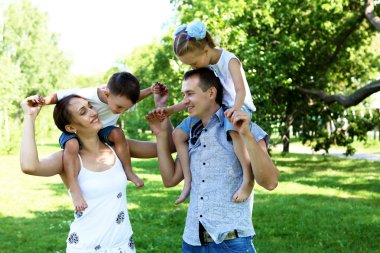 Family with two children in the summer park