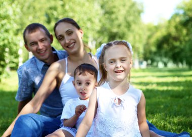 Family with two children in the summer park