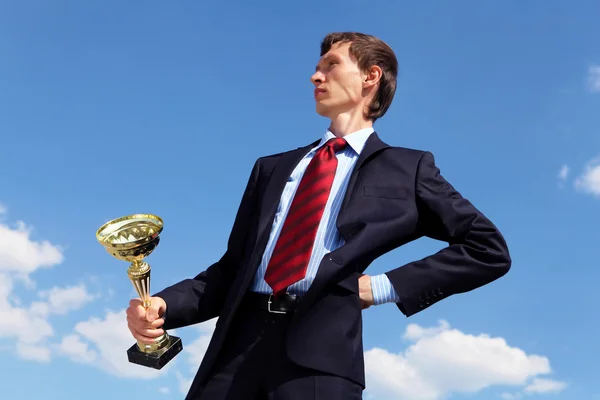 Young businessman with a golden cup — Stock Photo, Image