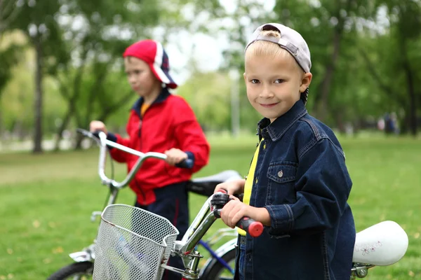 Boy on a bicycle in the green park — Stock Photo, Image