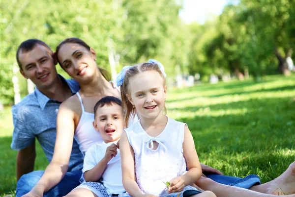 Family with two children in the summer park — Stock Photo, Image