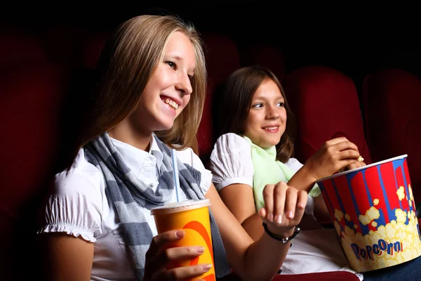 Two young girls watching in cinema — Stock Photo, Image