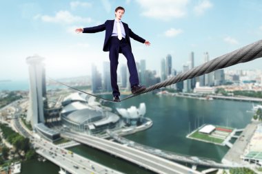 Business man balancing on the rope clipart