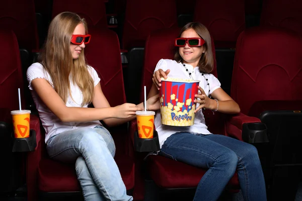 Two young girls watching in cinema — Stock Photo, Image