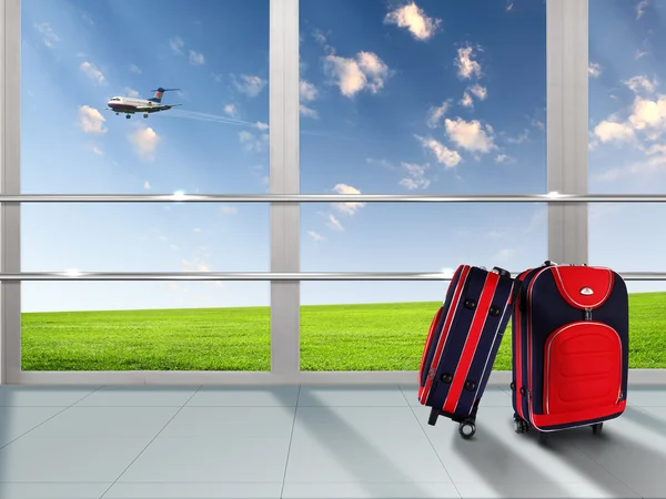 Κόκκινη βαλίτσα και αεροπλάνο — Φωτογραφία Αρχείου