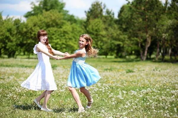 Two girls playing in the park Stock Image