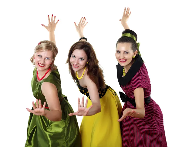 Три девушки в ярких цветовых платьях — стоковое фото