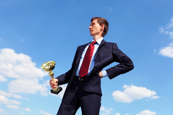 Young businessman with a golden cup — Stock Photo, Image