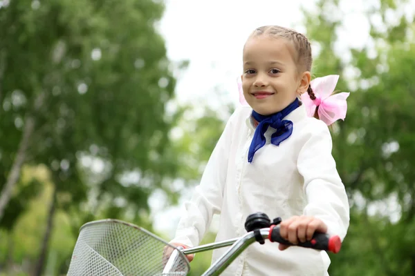 Kız bir bisiklet yeşil park — Stok fotoğraf