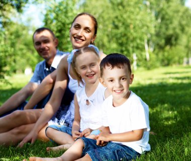 Family with two children in the summer park