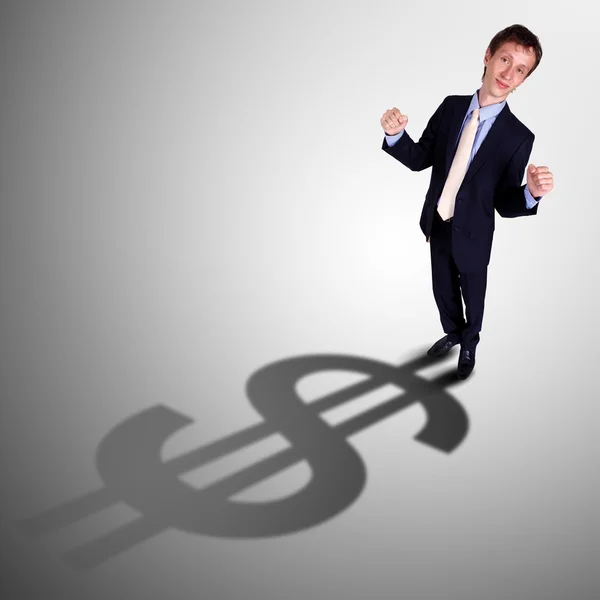 Businessman with shadow as a currency symbol — Stock Photo, Image