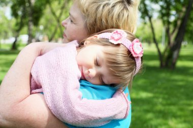 Grandmother with her granddaughter outdoors clipart